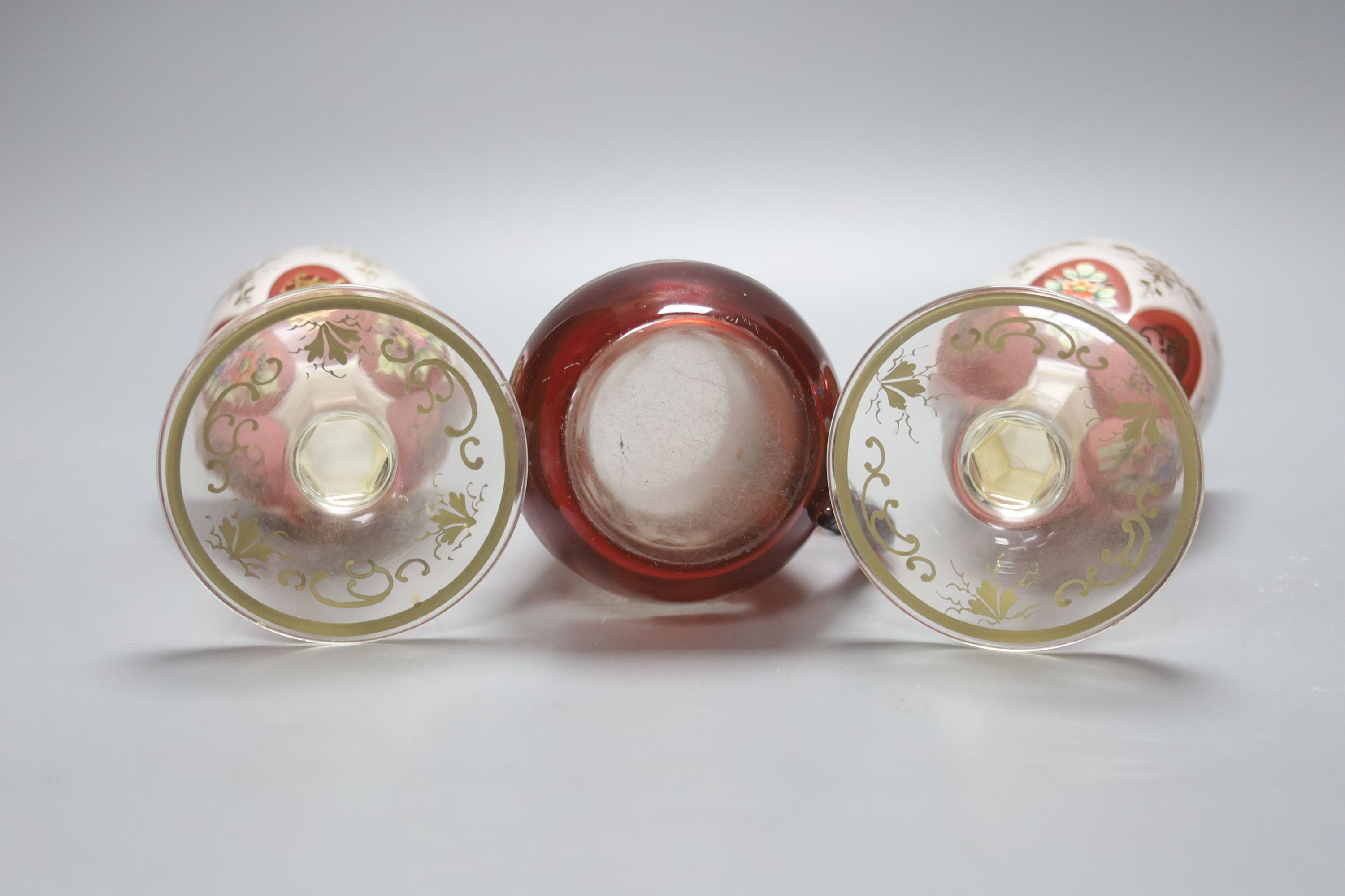 A pair of Bohemian overlaid glass goblets and a wheel engraved ruby glass jug (3) 15cm